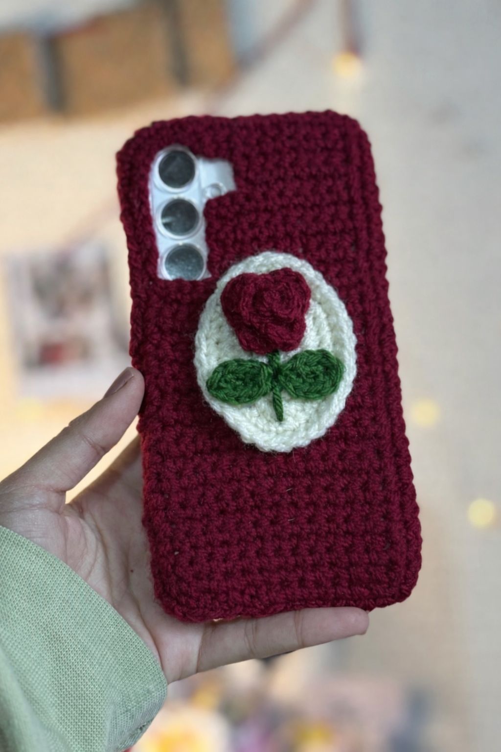 Maroon crocheted phone case with a rose design