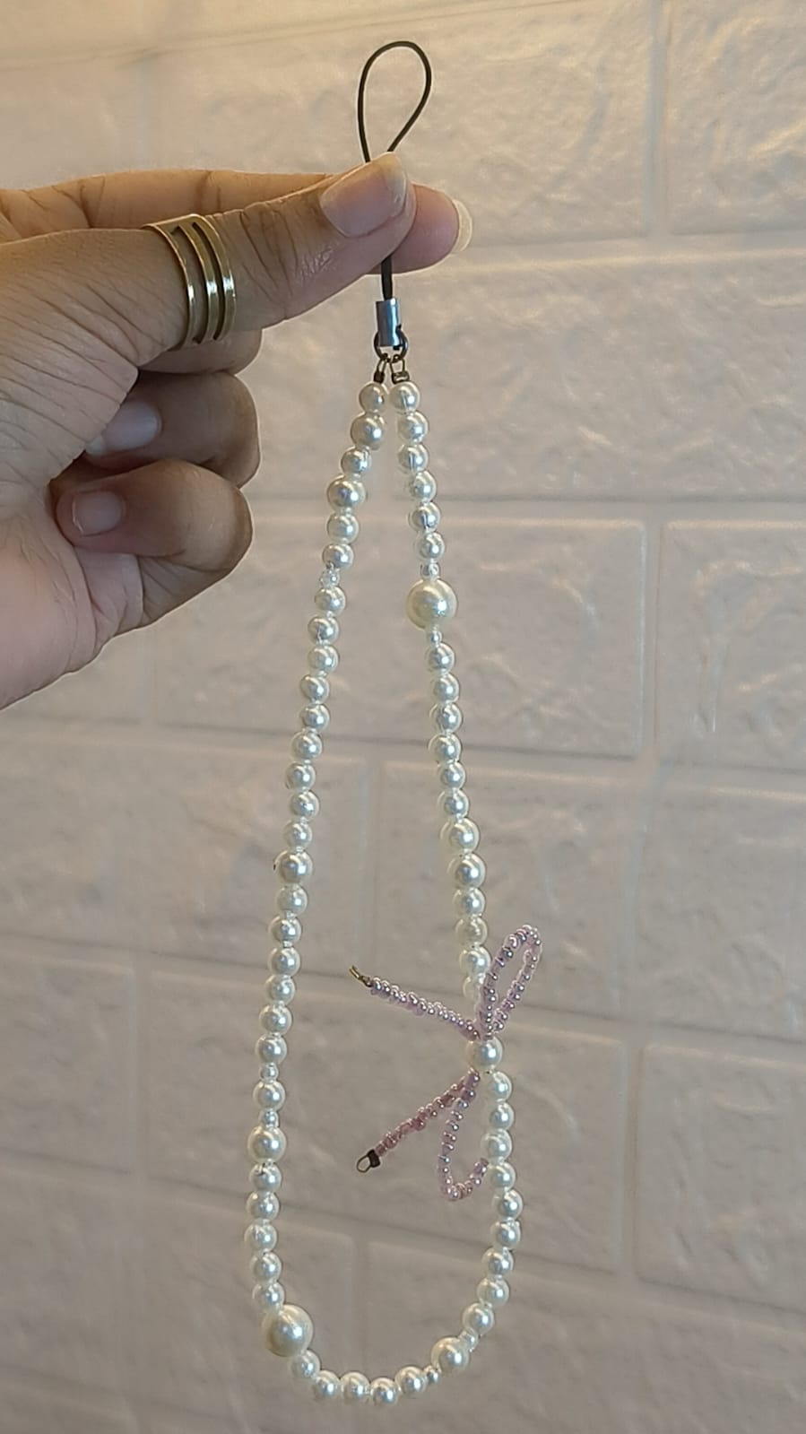Elegant handmade pearl bow phone charm strap with premium faux pearls for smartphones, handbags, keys and mobile accessories