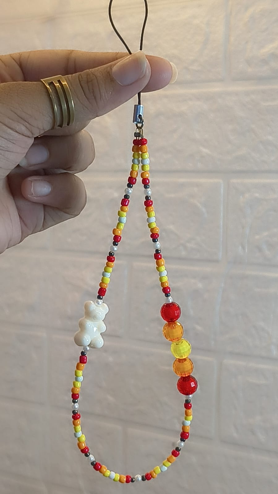 Handmade Sunset Teddy Beaded Phone Charm Strap with red, orange, yellow and white beads, glossy teddy bear charm and crystal accent beads for smartphones, handbags and keys.